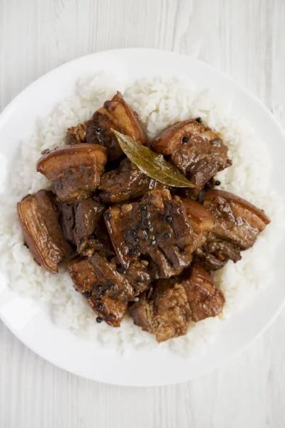 Fatto in casa filippino Adobo maiale con riso su un piatto bianco su whi — Foto Stock