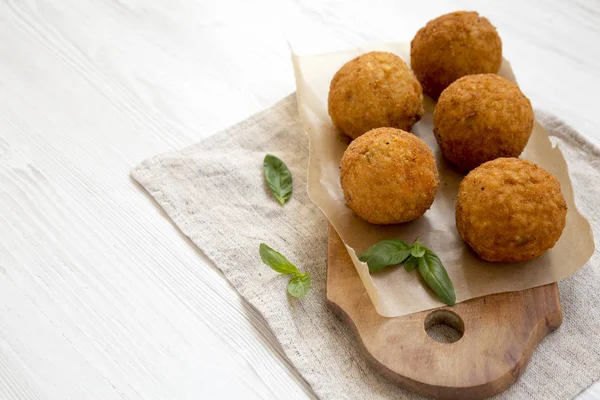 Homemade fried Arancini with basil on a rustic wooden board, sid — Stock Photo, Image