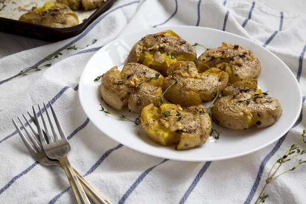 Timo all'aglio fatto in casa schiacciato patate su un piatto bianco, basso ang — Foto Stock