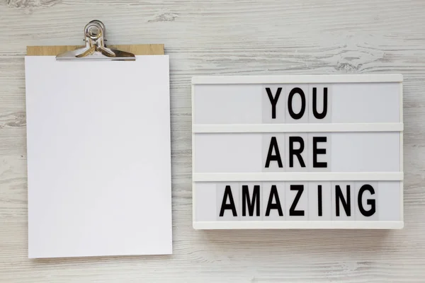 \'You are amazing\' words on a modern board, clipboard with blank