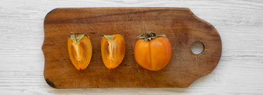 Beyaz ahşap arka plan üzerinde bir doğrama tahtası üzerinde taze hurma, 