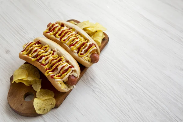 Homemade colombian hotdogs with pineapple sauce, chips, yellow m