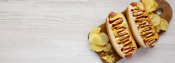 Homemade colombian hot dogs on a rustic wooden board on a white — Stock Photo, Image