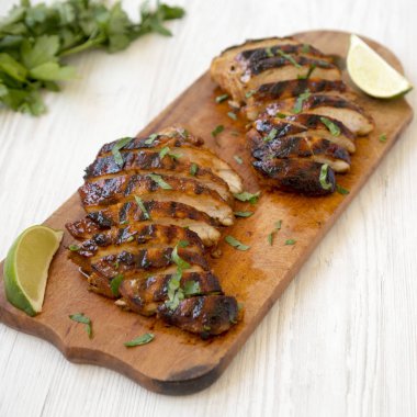 Bir wh üzerinde rustik ahşap tahta üzerinde ızgara chipotle tavuk göğsü