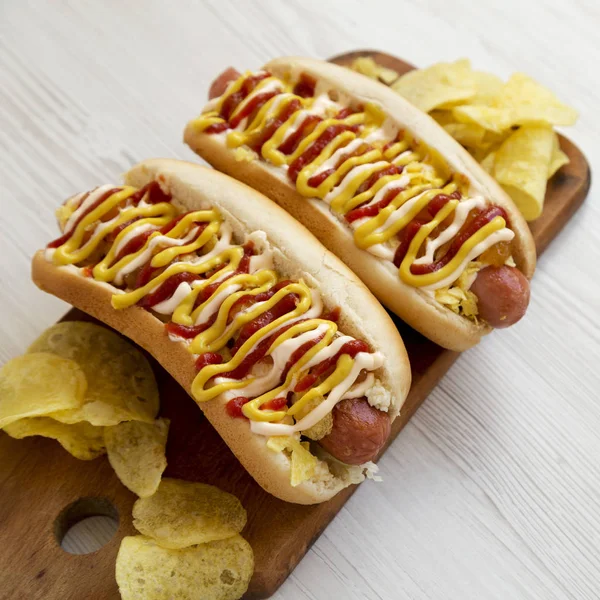 Homemade colombian hot dogs with pineapple sauce, chips, yellow