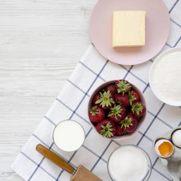 Strawberry pie ingredients (flour, eggs, butter, milk, sugar, st