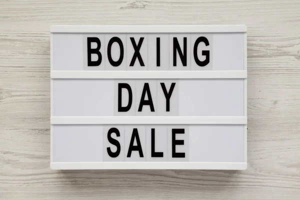 \'Boxing day sale\' words on a modern board on a white wooden surf