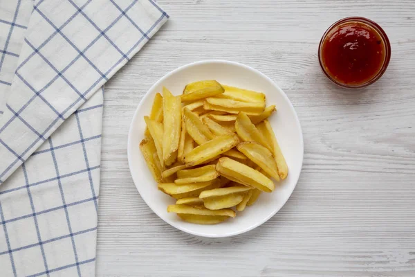 Homemade french fries with sour-sweet sauce on a white plate on — Stock Photo, Image