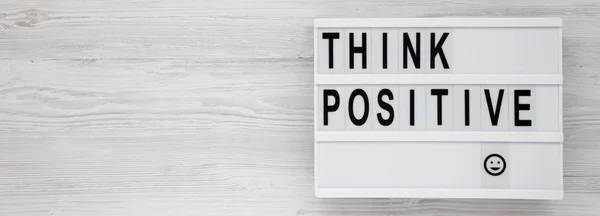 'Think positive' words on a modern board on a white wooden backg — Stock Photo, Image