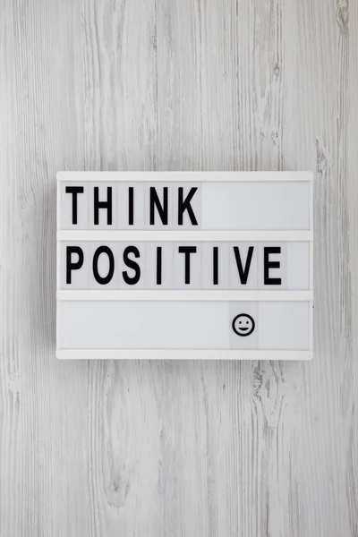 'Think positive' words on a modern board on a white wooden surfa — Stock Photo, Image