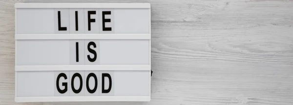 'Life is good' words on a lightbox on a white wooden background, — ストック写真