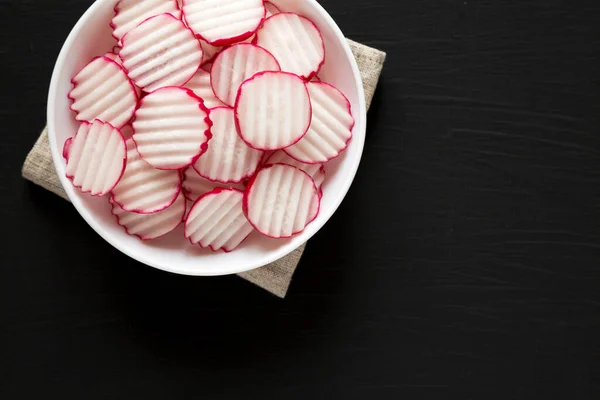 Fresh Radish Chips Slices White Bowl Black Background Top View — Stock Photo, Image