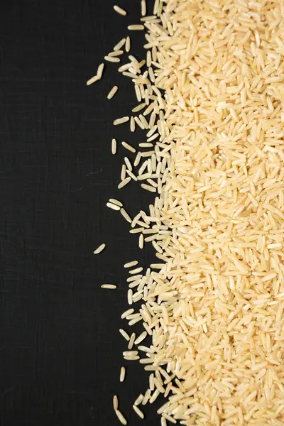 Dry Brown Rice Black Surface Top View Overhead Flat Lay — Stock Photo, Image