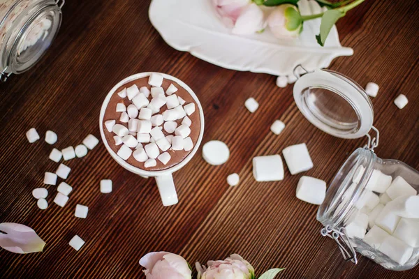 Cocoa with marshmallow and flowers.