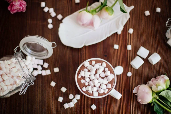 Cocoa with marshmallow and flowers.