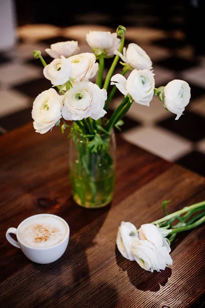 Cup of coffee and ranunculus. — Stock Photo, Image