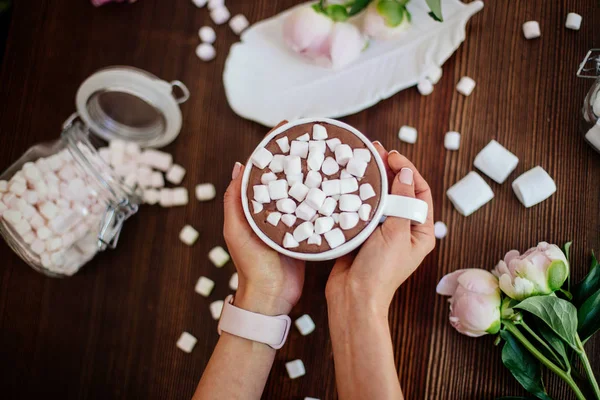 Cocoa with marshmallow and flowers.