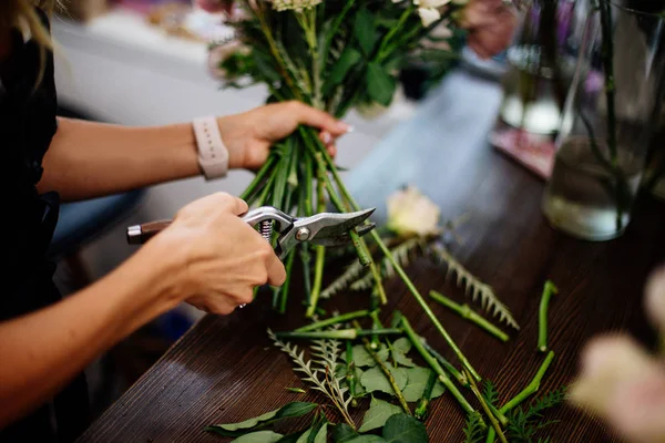 Florist makes a bouquet.