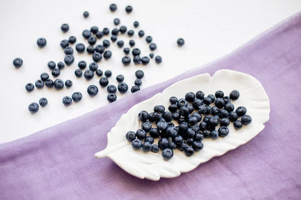 Blueberries on a white table. — Stock Photo, Image