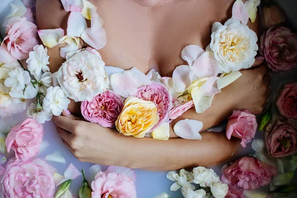 Hermosa chica en el baño con muchas flores . —  Fotos de Stock
