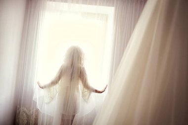 kız elbise ve peçe ayakta pencere, yakınındaki giyimli kadın önce düğün töreni hazırlanıyor