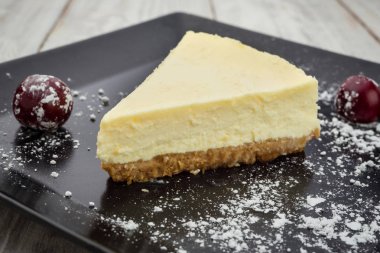 Siyah plaka üzerinde çilek ile klasik New York cheesecake. Tatlı kavramı 