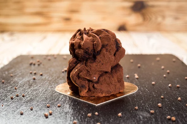 Chocolate truffle cake on stone background