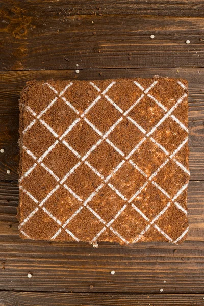 Koyu çikolata vegan kek şekerler ve ahşap zemin üzerine fındık