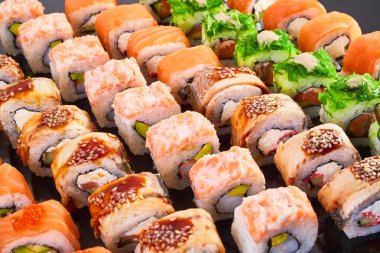 Menü için siyah arka plan lezzetli suşi rulo çeşitli. Japon yemekleri