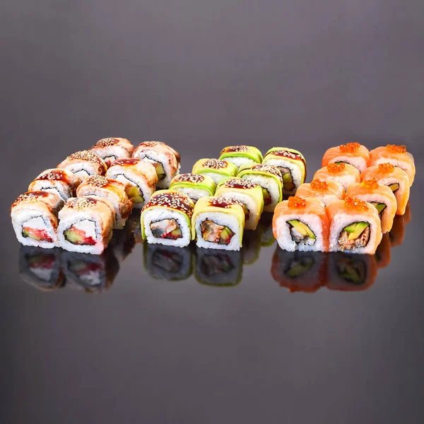 I vari generi di rotolo di sushi saporito su sfondo nero per menù. Cibo giapponese — Foto Stock