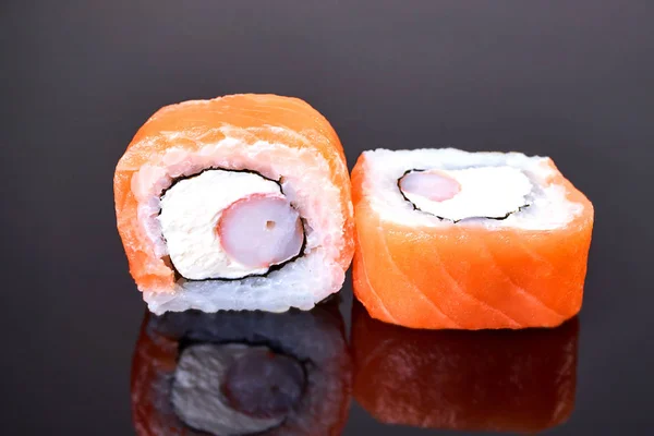 Philadelphia roll sushi with salmon, crab sticks and cream cheese on black background for menu. Japanese food — Stock Photo, Image