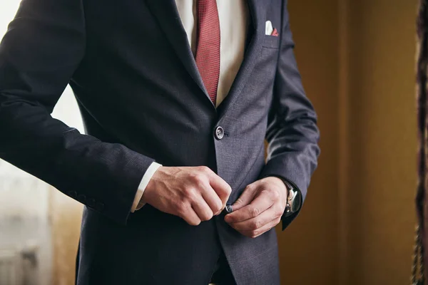 Empresario lleva una chaqueta, manos masculinas primer plano, novio preparándose en la mañana antes de la ceremonia de boda — Foto de Stock