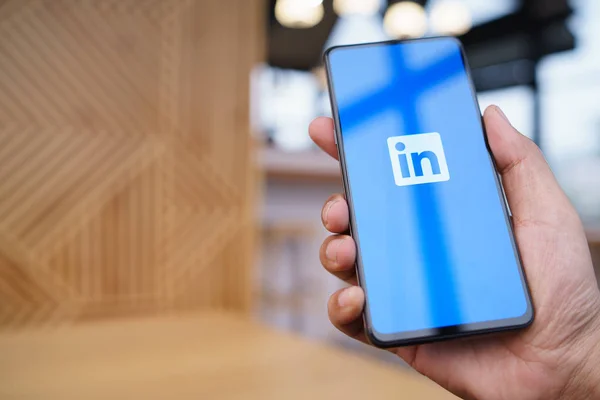 CHIANG MAI, THAILAND - Mar. 23,2019: Man holding Xiaomi Mi Mix 3 mobile phone with Linkedin application on the screen. Linkedin is a business and employment oriented social networking service. — Stock Photo, Image
