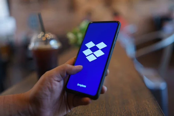 CHIANG MAI, THAILAND - Mar. 24,2019: Man holding Xiaomi Mi Mix 3 with Dropbox on screen.Dropbox is a service that gives you access to images, documents and videos online from anywhere. — Stock Photo, Image