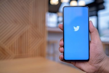 Chiang Mai, Tayland - Mar. 23,2019: Ekranda Twitter uygulaması ile Xiaomi Mi Mix 3 tutan adam. Twitter, kullanıcıların mesaj gönderdiği ve mesajlarla etkileşimde bulunduğu bir çevrimiçi haber ve sosyal ağ hizmetidir..