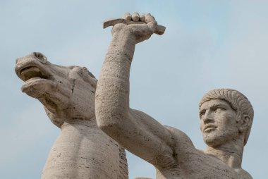 Close up to the Statue of a Horse and a Man in front of Palazzo della Civilta Italiana, Colosseo Quadrato, EUR, Expo, Rome, Italy,  Esposizione Universale