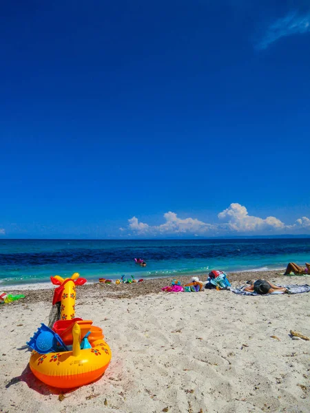 Colorful Baby life-belt on the beach of Porto Ainu, near Budoni, Gallura, East Sardinia, Sardinia, Italy, Europe