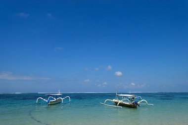 Gili Adaları, Gili Trawangan, Gili Meno, Gile Air 'deki gelgit sırasında geleneksel stil kano balıkçı tekneleri Jukung. Teknelere iki bambu dengeleyici takıldı, her iki tarafa da, alabora olma ihtimalini azaltmak için. Jukung olarak biliniyor. Bali, 