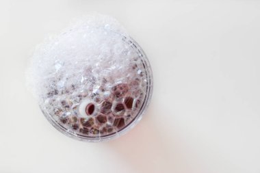 beyaz arka plan üzerinde bir cam sabun kabarcıkları