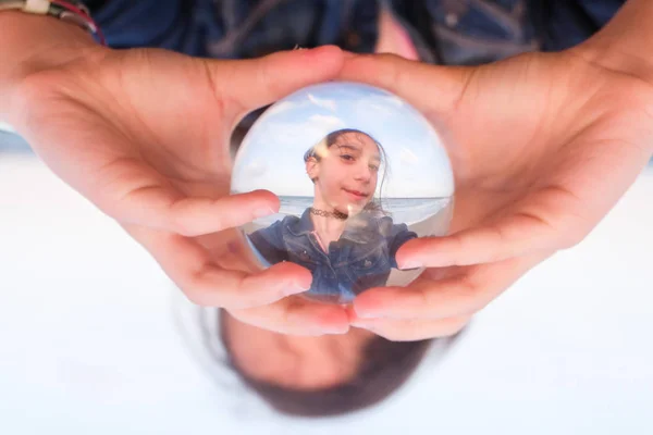 Teenager seen through a lensball — Stock Photo, Image