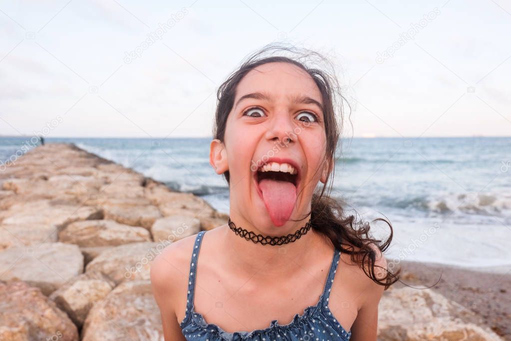 Teen making faces and sticking out her tongue