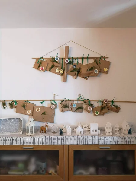 Handmade advent calendar hanging from a wooden stick — Stock Photo, Image