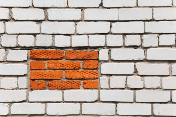 White brick wall background with orange rectangle. Background with an emphasis with copy space. Accent. Orange, red, white bricks