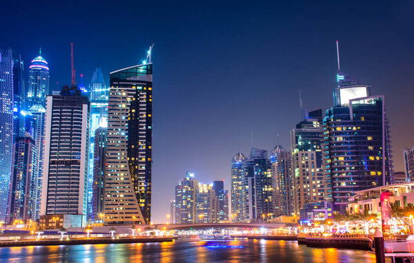 Night beauty of Dubai marina colorful light with lake view, modern city place to visit in United Arab Emirates luxury life