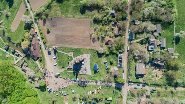 Aerial view of the village. Church. People. Field. Road. Aerial photography. Cold Yar. Medvedovka. Ukraine.