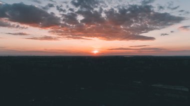 Havadan görünümü günbatımı. Mavi gökyüzü. Bulutlar. Turuncu güneş.