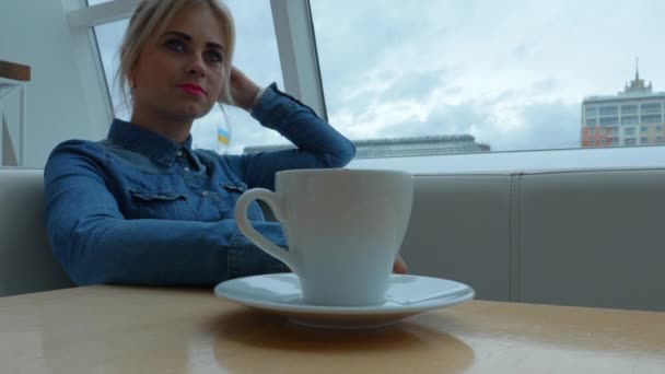 Blonde Girl Sitting Couch Cafe Table Cup Coffee — Stock Video