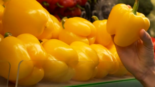 Young Guy Chooses Yellow Bell Pepper Supermarket Hand Takes Yellow — Stock Video