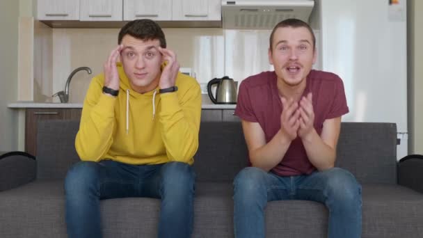 Two Men Sitting Couch Watch Football Match Support Different Teams — Stock Video