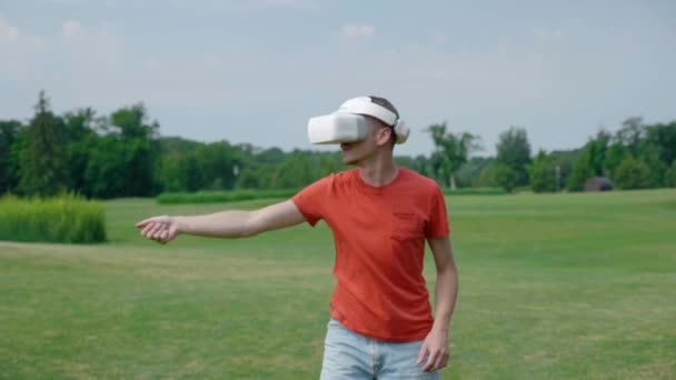 Man Using Headset Playing Virtual Game Park Young Guy Helmet — Stock Video